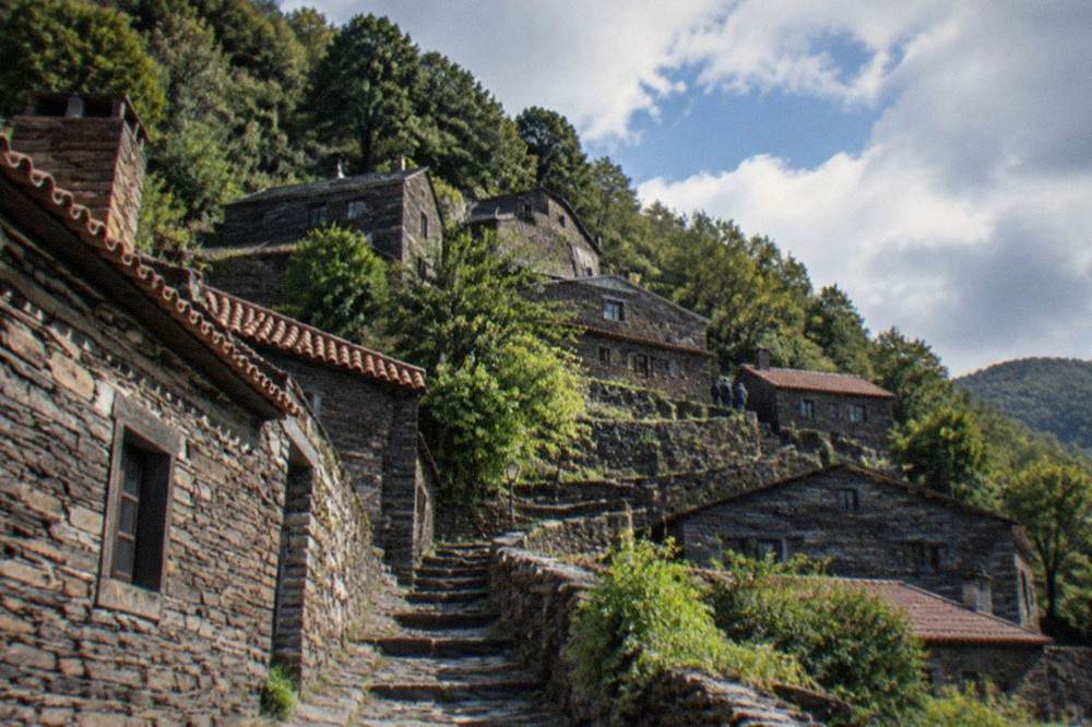 A stone schist village terrace on the Lousã mountain above forested slopes