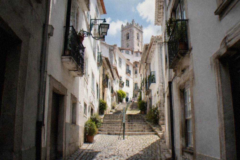 Narrow cobbled lane with old stone houses in the Alta upper town of Coimbra