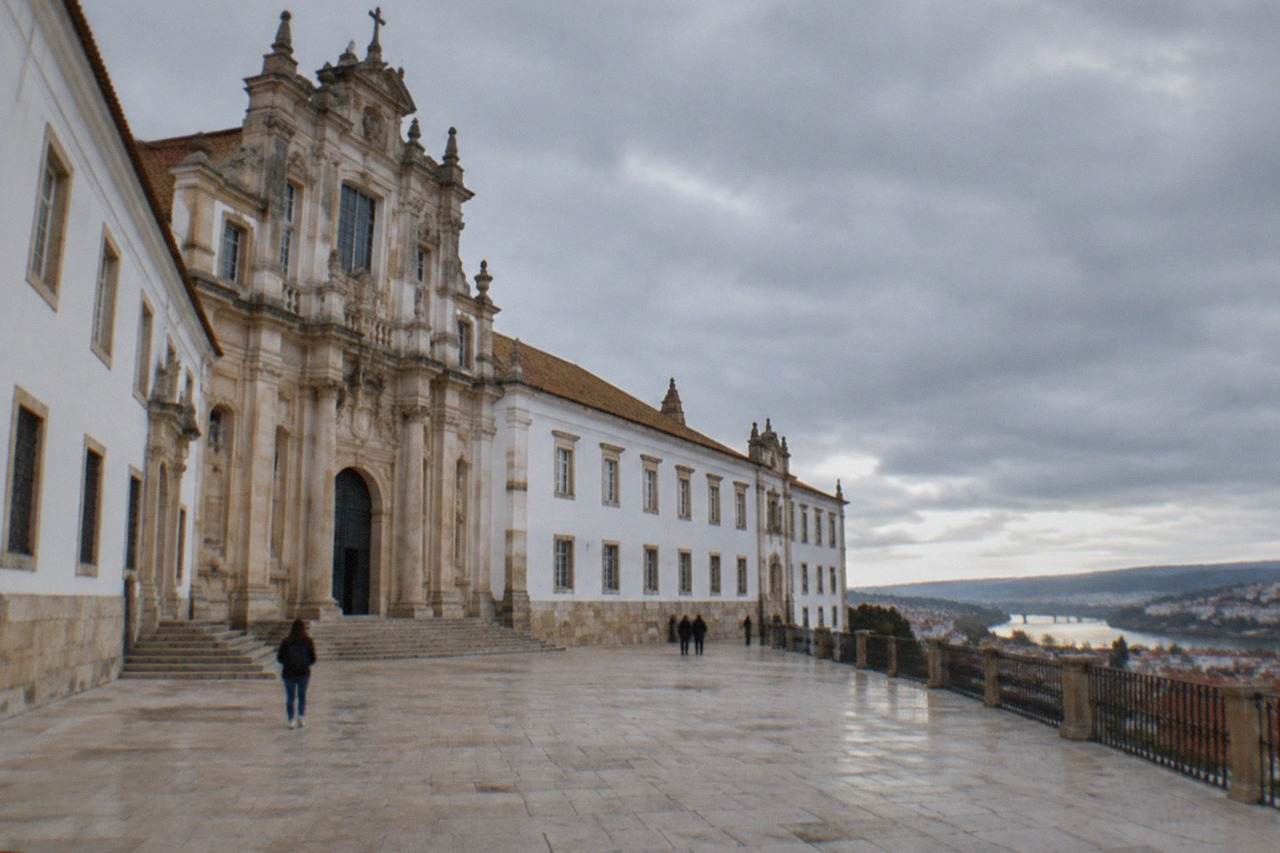 The grand baroque facade of the University of Coimbra buildings on the hill above the River Mondego