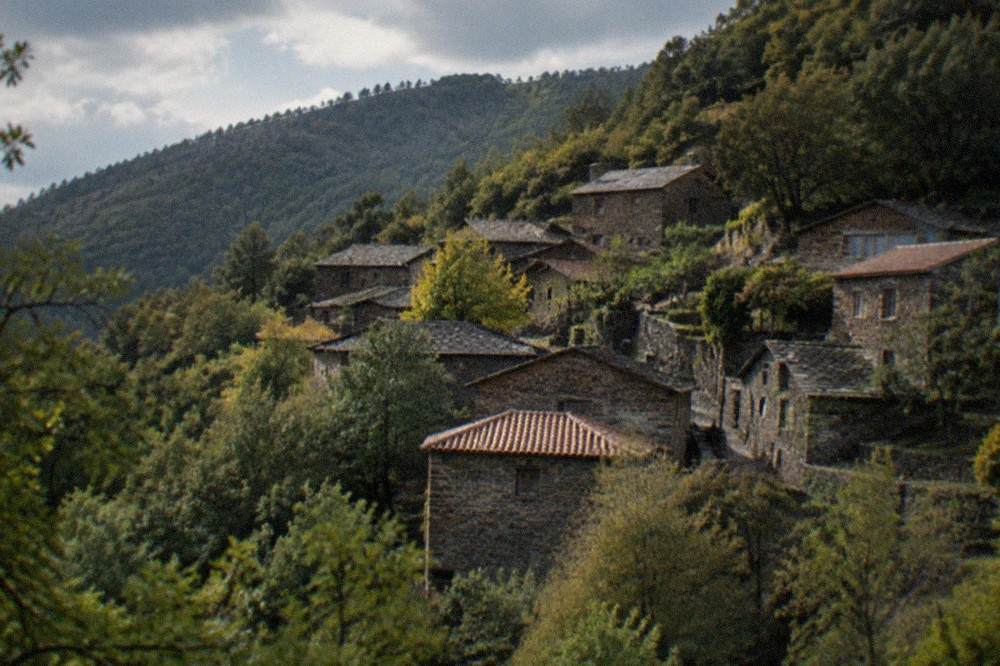 Stone schist village houses on a forested slope of the Lousã mountain near Coimbra