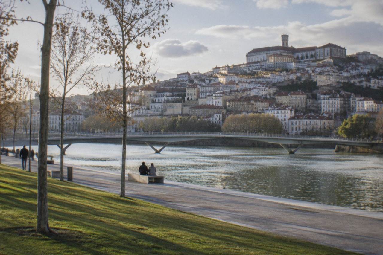 The old university hill of Coimbra seen across the River Mondego on a warm clear afternoon
