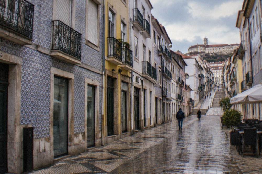 The steep cobbled streets of Coimbra's old town rising toward the university buildings