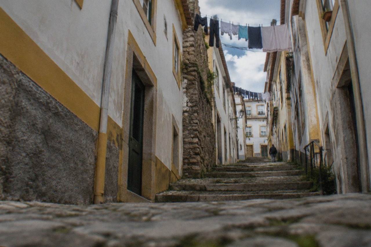 Steep medieval streets of Coimbra's old town rising toward the university hill in Portugal