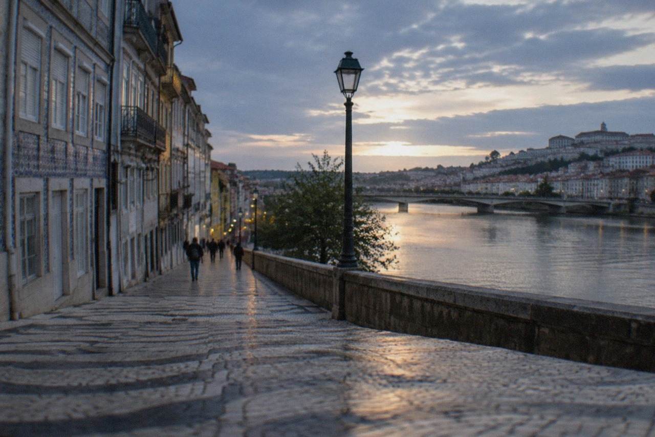 The riverside lower town of Coimbra seen from the university hill, with tiled facades above the Mondego