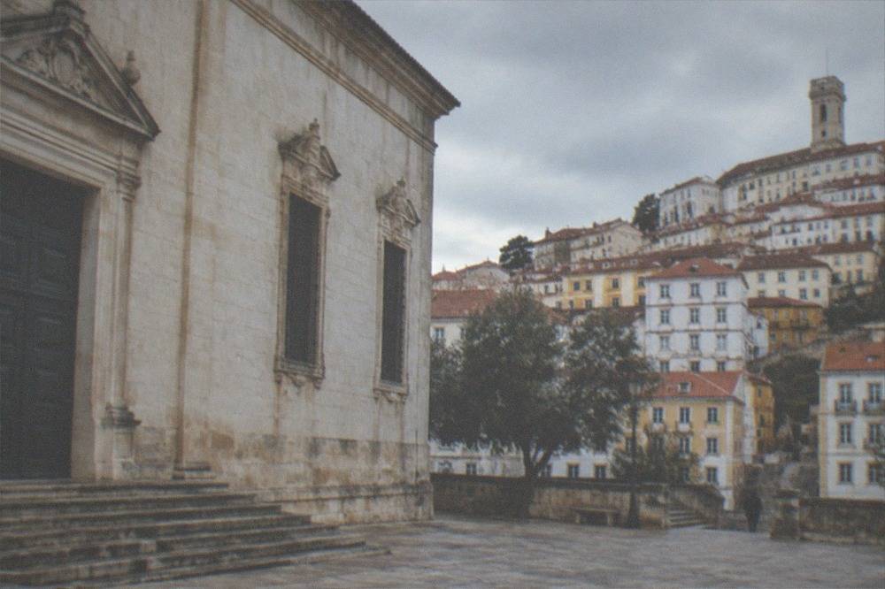 Closed stone facade of a museum building on a quiet square in Coimbra