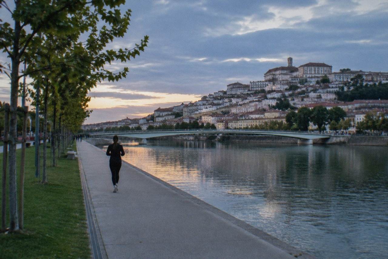 The Mondego river at Coimbra seen from the Santa Clara bank, with the old town and university buildings on the far side