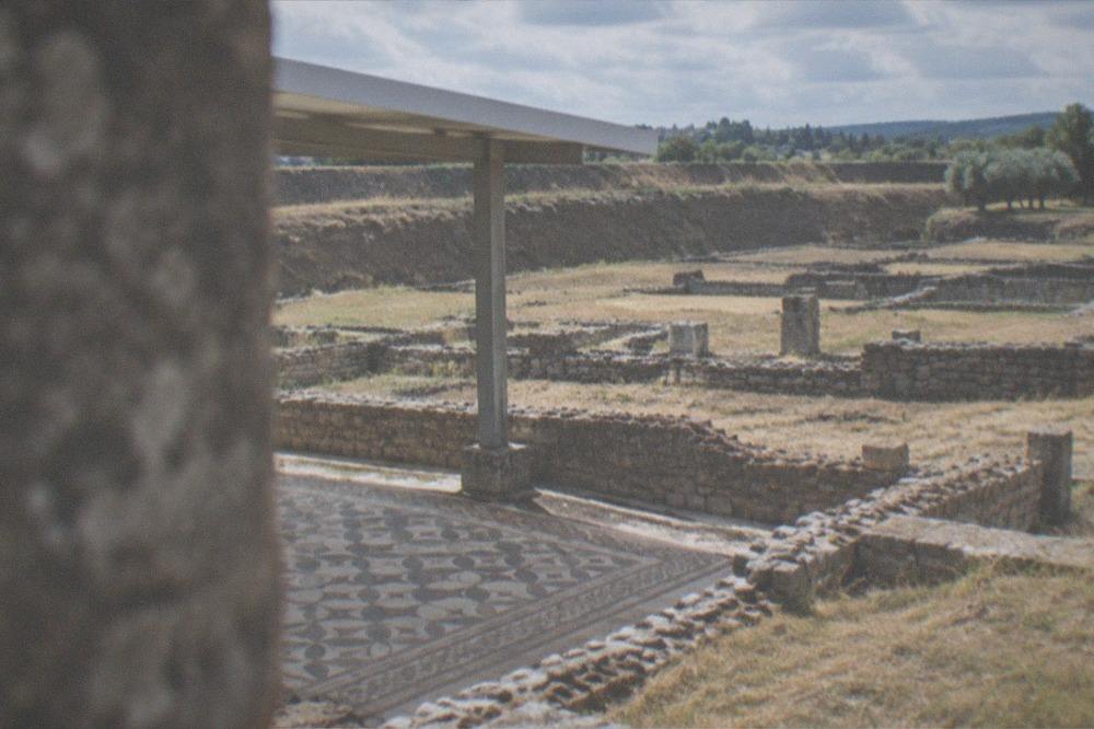 Stone foundations and low walls of Roman ruins under an open sky in central Portugal