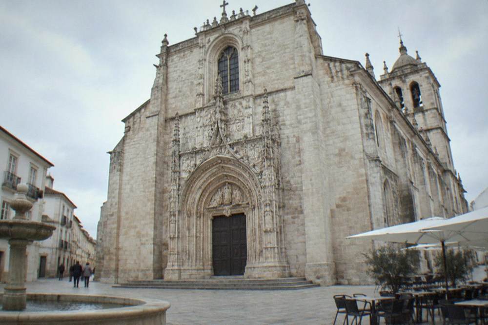 Ornate stone portal of the Mosteiro de Santa Cruz seen from the square in front