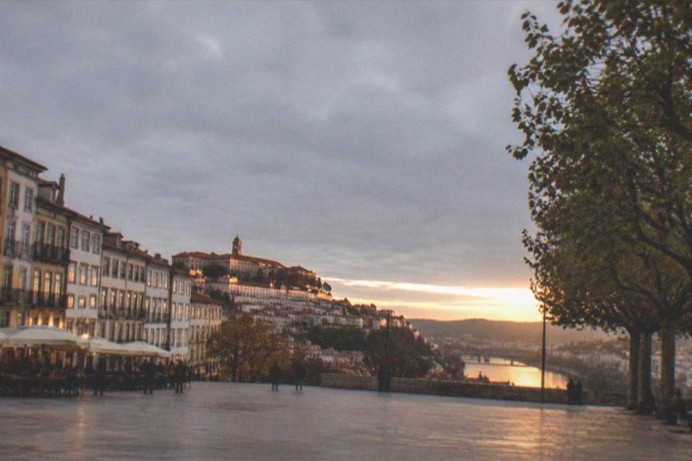 Evening light on the walls of the university hill with the chapel silhouette and the river valley below