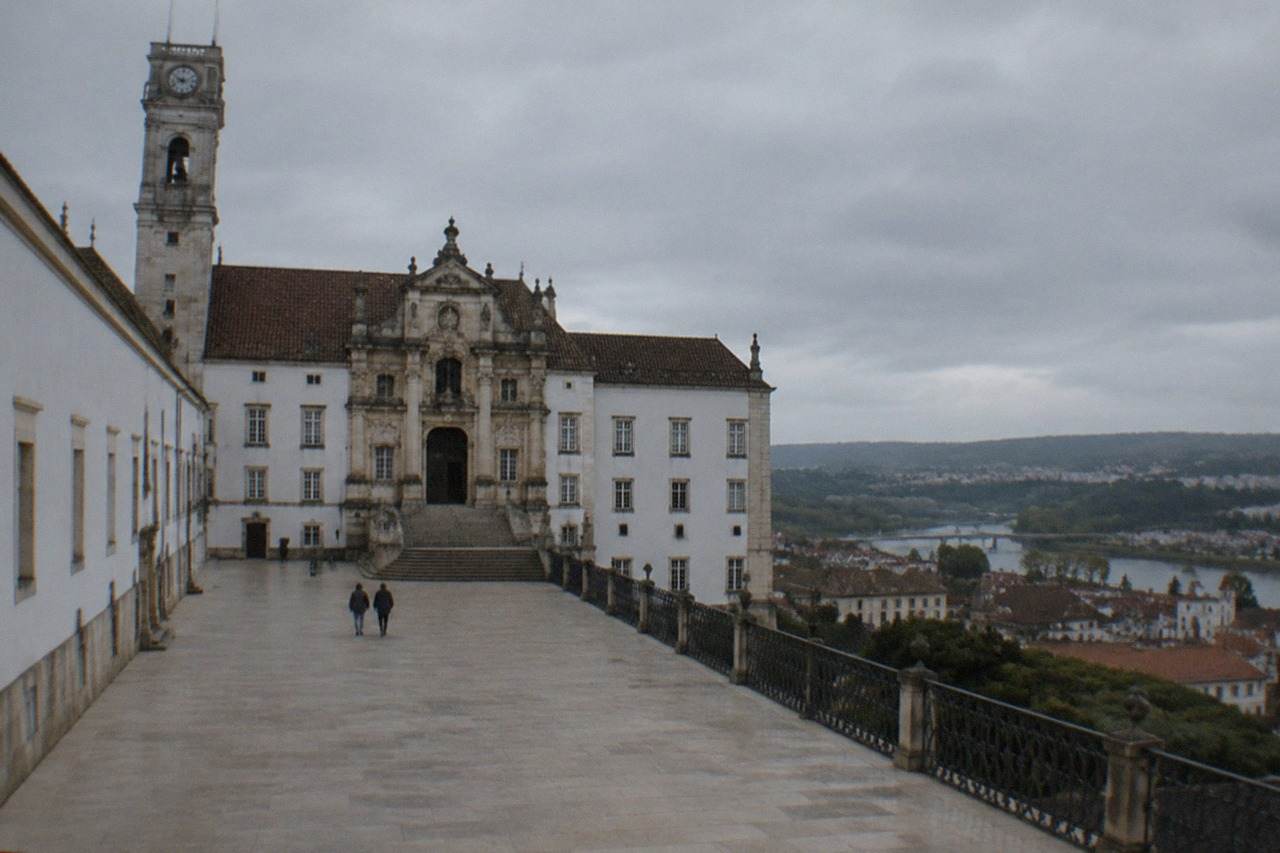 The grand baroque facade of the University of Coimbra's Paço das Escolas seen from the lower town