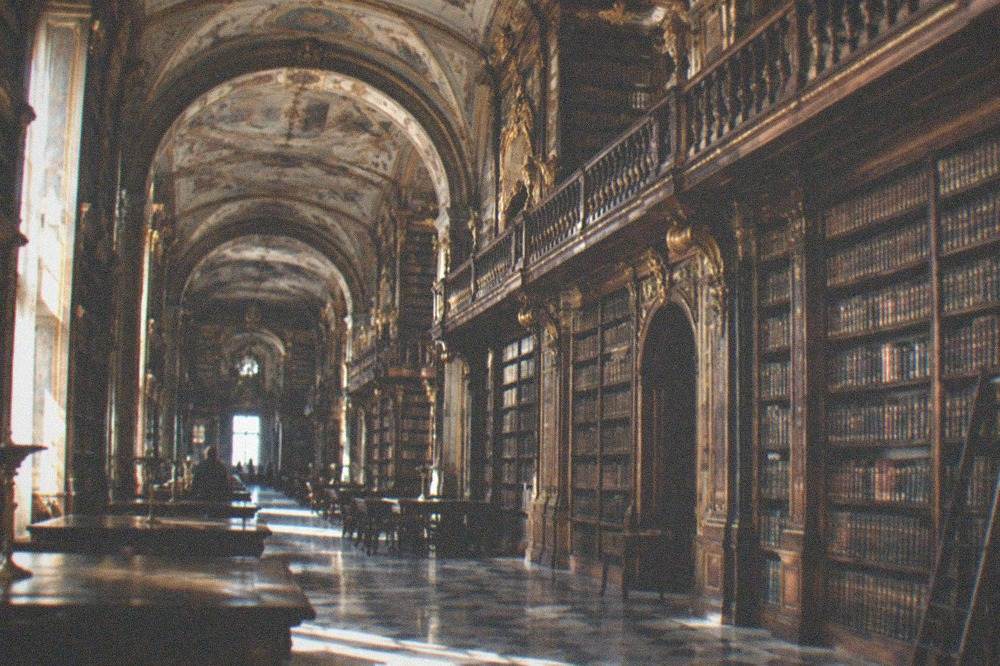 The baroque interior of the Joanina Library with its painted ceilings and gilt bookshelves