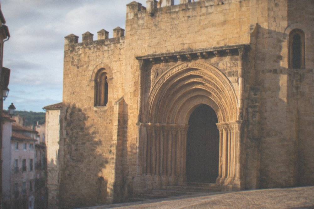 The carved Romanesque doorway of the old cathedral of Coimbra in warm afternoon light