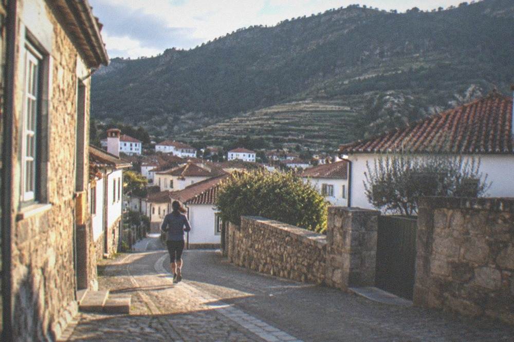 A quiet village street of stone houses on the Lousã mountain route