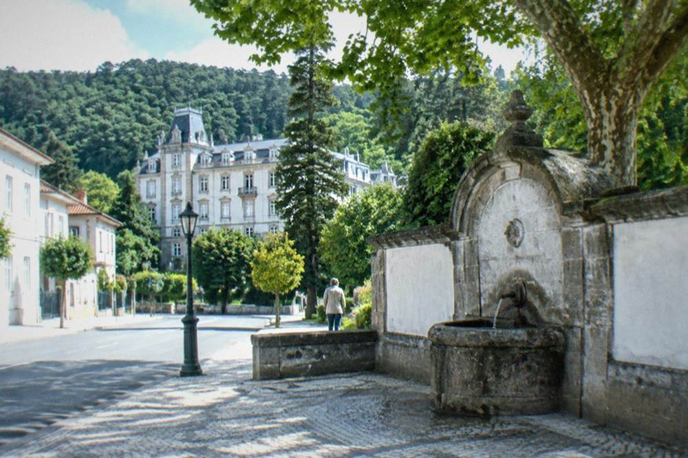 A grand stone palace hotel surrounded by forest in central Portugal