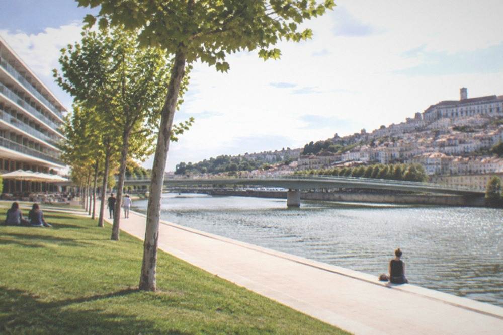 Riverside hotel balconies facing the River Mondego and the old town of Coimbra