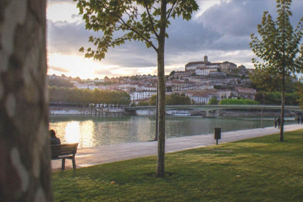 The lower town of Coimbra and the Mondego riverfront at dusk