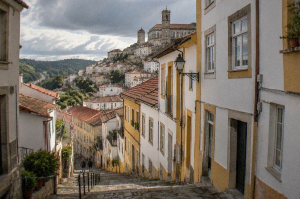 A road winding through green hills between Porto and central Portugal
