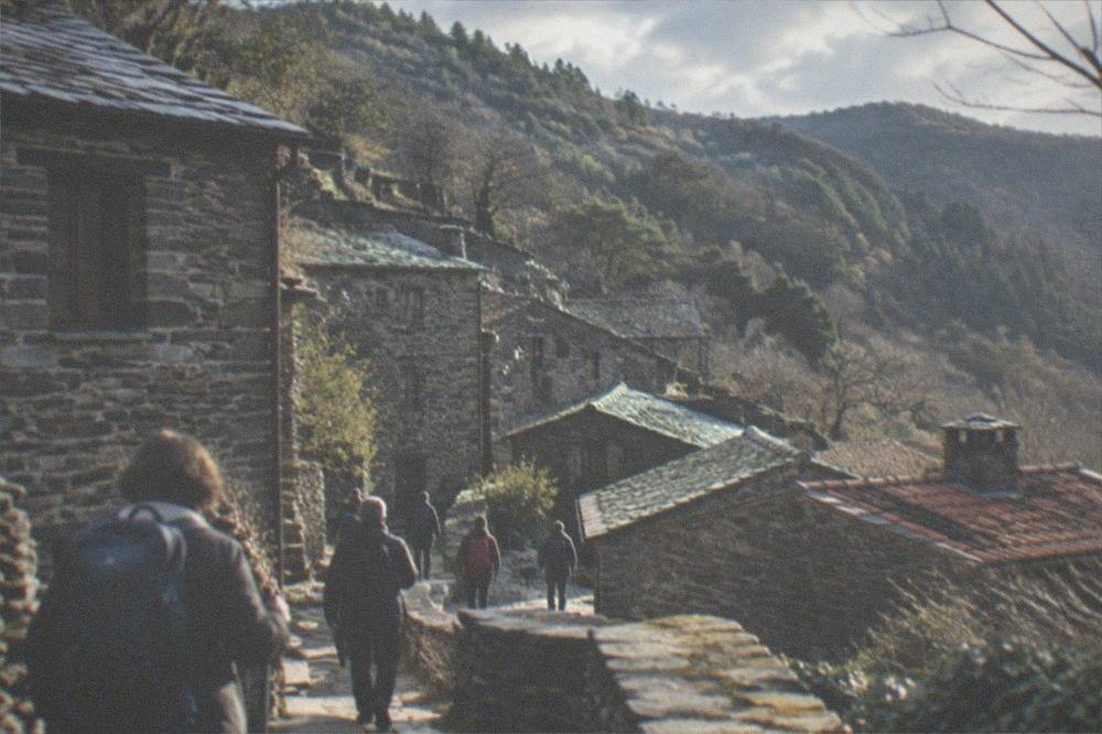 A guided group walking among the stone houses of a schist village on Lousã mountain