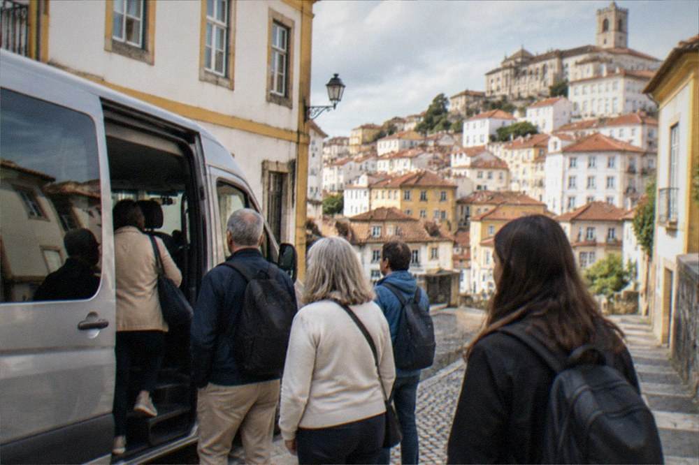 A day-trip group boarding a minivan outside a Coimbra hotel in the morning