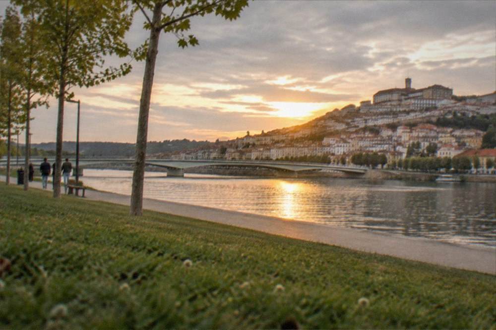 Warm evening light on the Mondego river and the old town of Coimbra