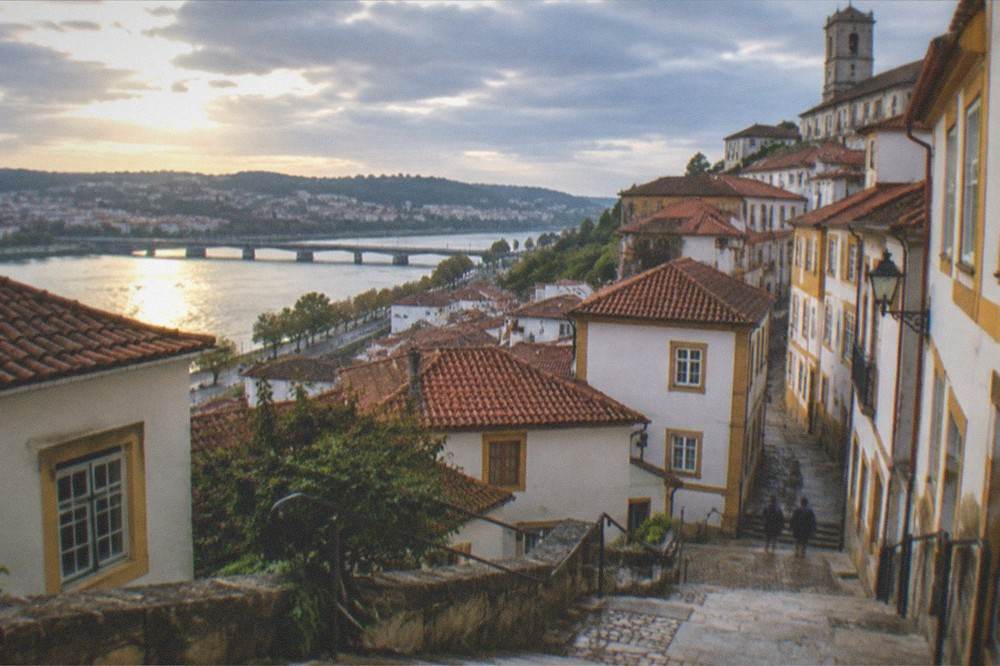 The steep stairway streets of Coimbra's upper old town with the river visible below
