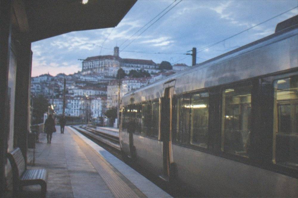 A train waiting at a platform at a Portuguese railway station