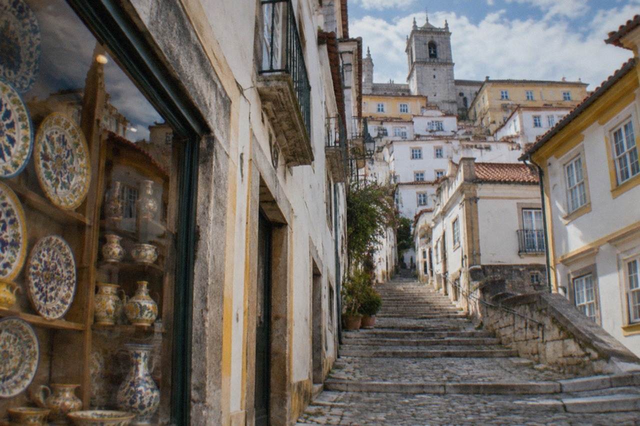 A shop window in Coimbra displaying painted ceramic plates and pottery