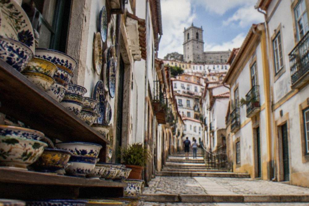 Rows of hand-painted ceramic bowls in a Coimbra pottery shop