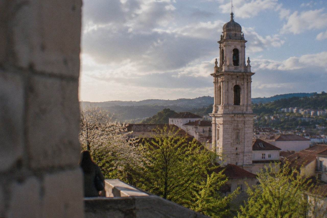 Spring view over Coimbra, Portugal, with the university tower above the old town rooftops