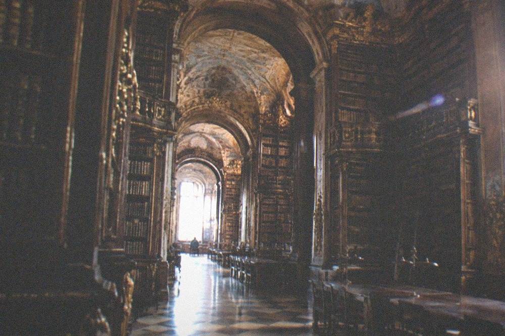 The baroque interior of the Joanina Library with its gilded bookshelves and reading tables