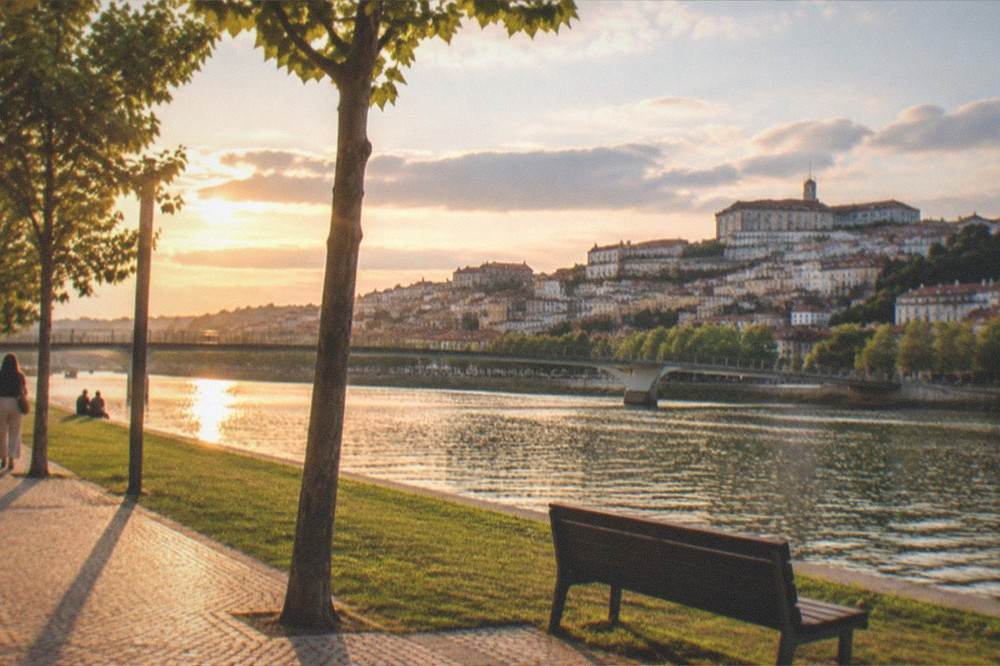 A quiet riverside walk along the Mondego in Coimbra at golden hour