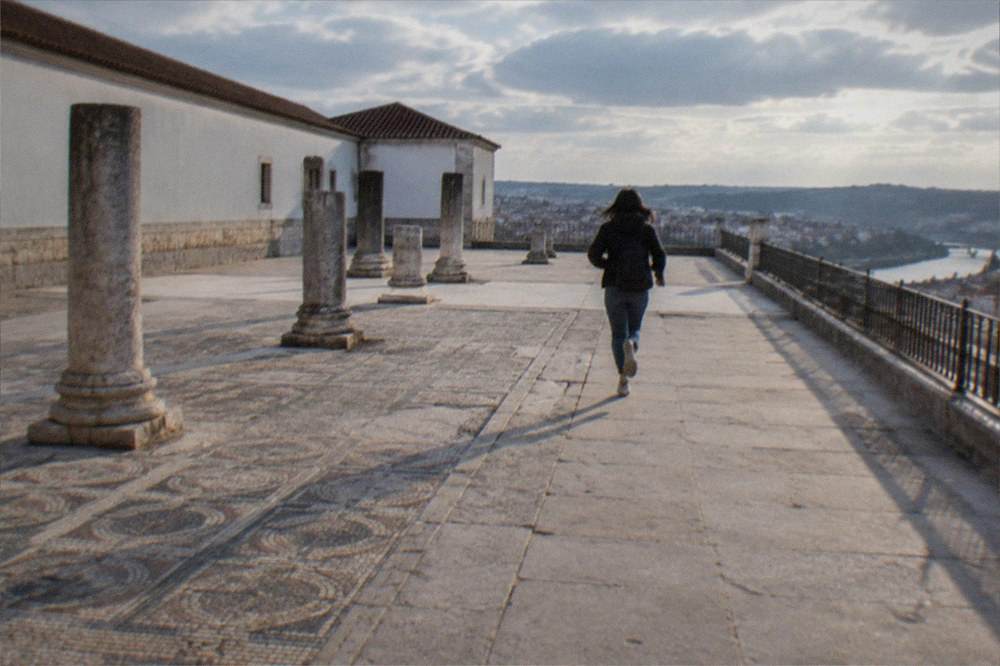 Ancient Roman mosaic floors and column bases at an archaeological site under open sky