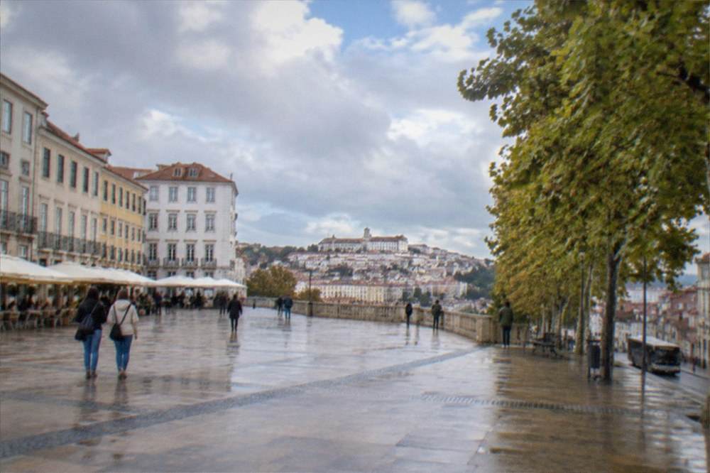A city bus on a narrow street in the lower town of Coimbra below the university hill