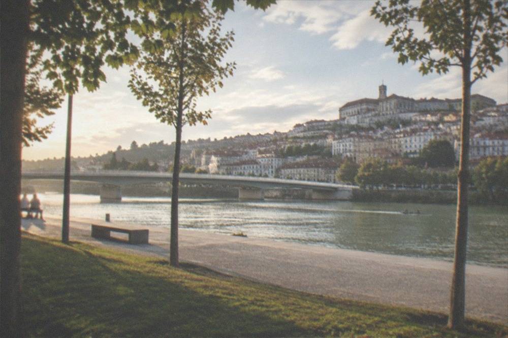 Golden late-afternoon light on the Mondego riverfront in Coimbra in September