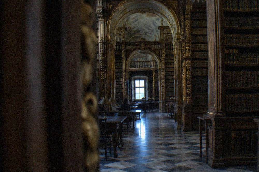 The baroque interior of the Biblioteca Joanina with its gilded bookshelves