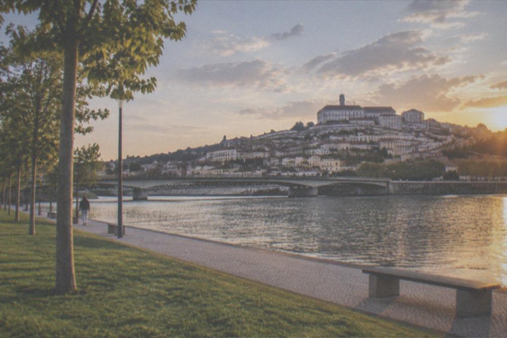 River Mondego in Coimbra with the city skyline and bridge in evening light